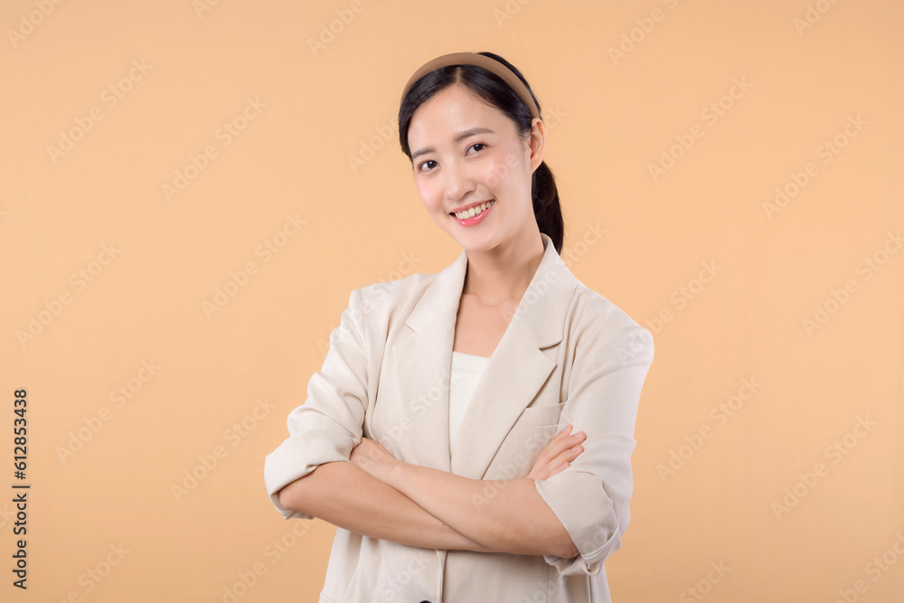 Studio portrait of happy successful confident young asian business woman. Beautiful young lady in white jacket smiling at camera standing isolated on solid beige colour copyspace background Studio portrait of happy successful confident young asian business woman. Beautiful young lady in white jacket smiling at camera standing isolated on solid beige colour copyspace background