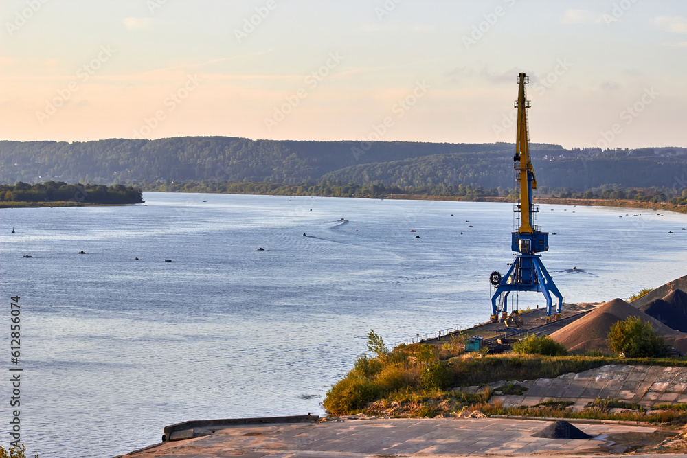 Obraz premium Rusty blue port cranes stands at the river.