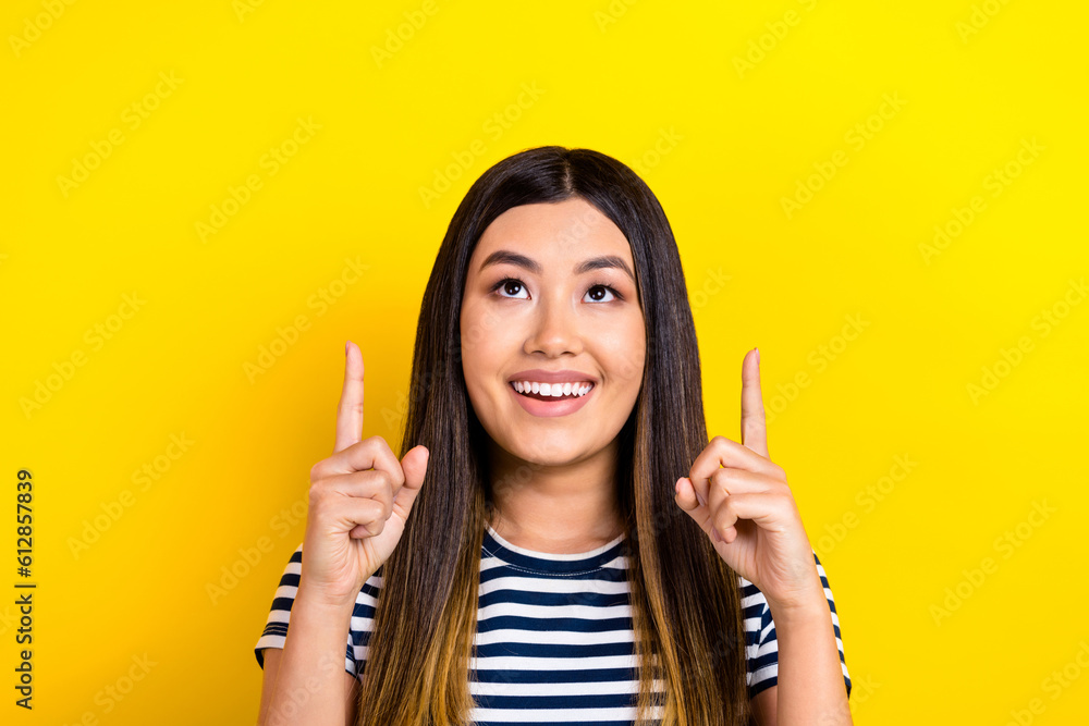 Portrait of cute asian girl direct fingers look up empty space sale shopping proposition season prices isolated yellow background Portrait of cute asian girl direct fingers look up empty space sale shopping proposition season prices isolated yellow background