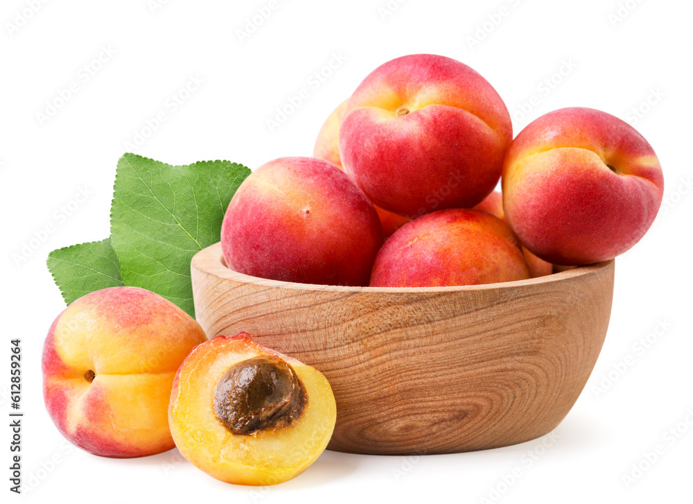 Apricots in a wooden plate with leaves close-up on a white background. Isolated Apricots in a wooden plate with leaves close-up on a white background. Isolated
