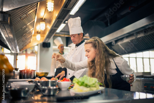 Apprentice chefs are cooking in the kitchen in a cooking school.