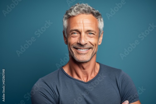 Close-up portrait photography of a beautiful mature man giving a hug to the camera against a soft blue background. With generative AI technology