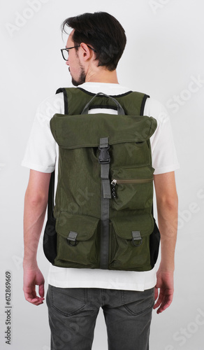 portrait of a man with a tourist backpack standing with his back on a transparent background