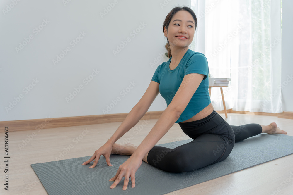 Slim woman practicing yoga on room of her condo or home. Asian woman doing exercises in morning. balance, meditation, relaxation, calm, good health, happy, relax, healthy lifestyle, diet, slim Slim woman practicing yoga on room of her condo or home. Asian woman doing exercises in morning. balance, meditation, relaxation, calm, good health, happy, relax, healthy lifestyle, diet, slim