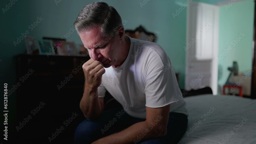 Anxious preoccupied older man sits by bedside feeling worry. Stressed desperate middle-aged person feeling suffering from mental illness Anxious preoccupied older man sits by bedside feeling worry. Stressed desperate middle-aged person feeling suffering from mental illness