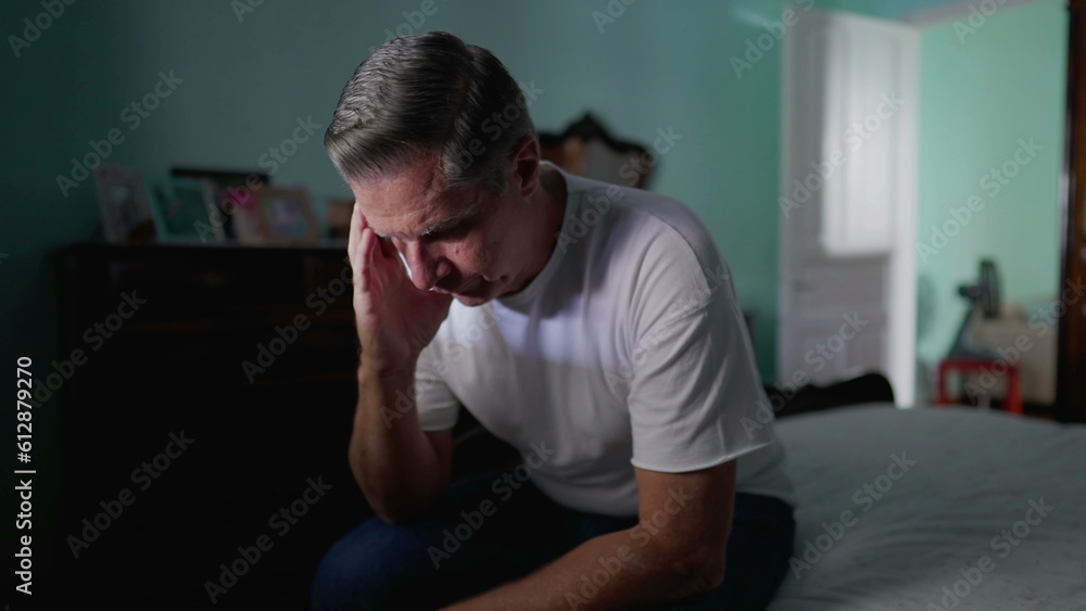 Anxious preoccupied older man sits by bedside feeling worry. Stressed desperate middle-aged person feeling suffering from mental illness Anxious preoccupied older man sits by bedside feeling worry. Stressed desperate middle-aged person feeling suffering from mental illness