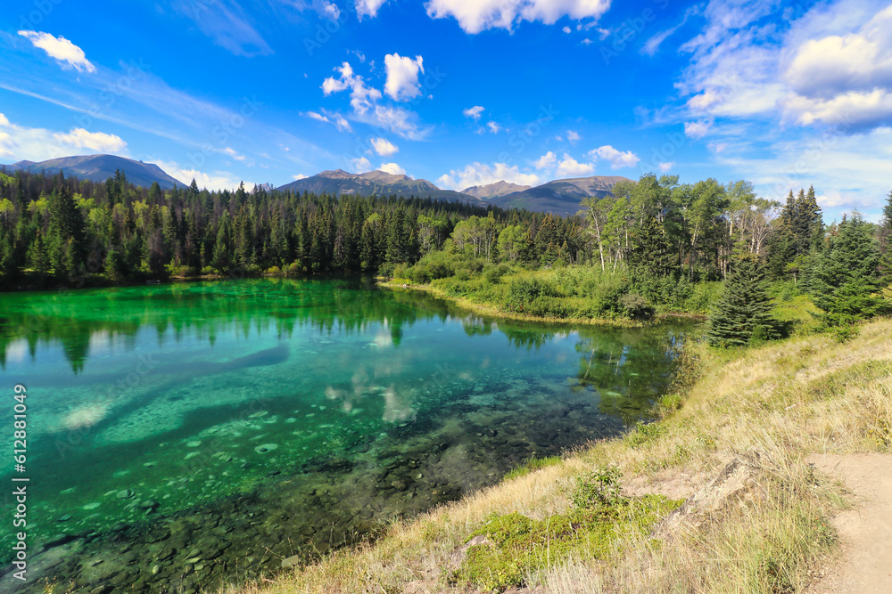 Crystal clear, emerald and sapphire hued lake waters in the Valley of Five Lakes region of Jasper in the Canada Rockies