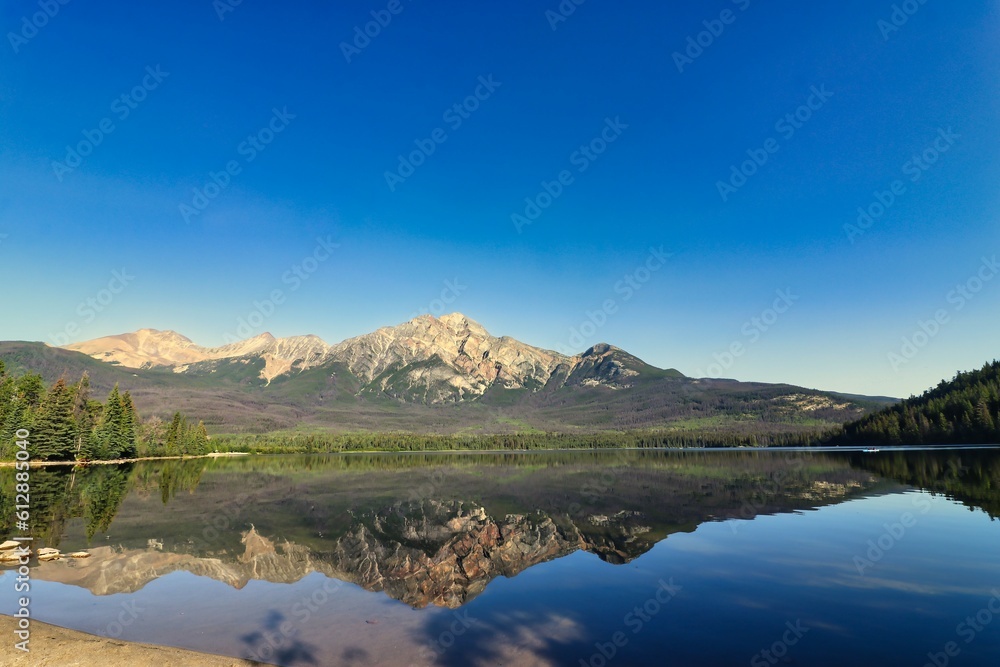 Pyramid Mountain reflected in the early morning, crystal waters of Pyramid lake near Jasper in the Canada Rockies