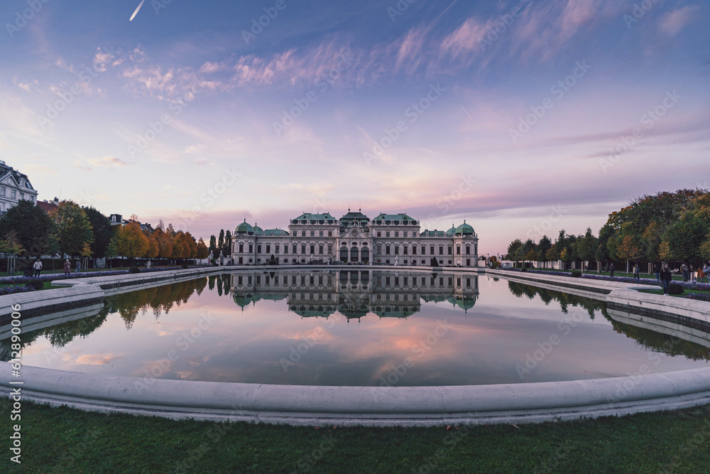 belvedere palace in Vienna at pink sunset and purple flowers - obrazy, fototapety, plakaty 
