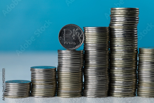 Silver coins in stacks on a blue background