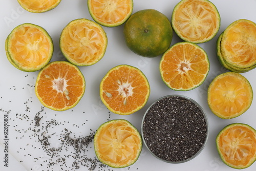 Half sliced Nagpur oranges along with a bowl of chia seeds