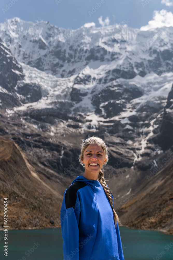 Naklejka premium Portrait woman traveler in front of Humantay lake in Cusco. Trekking concept