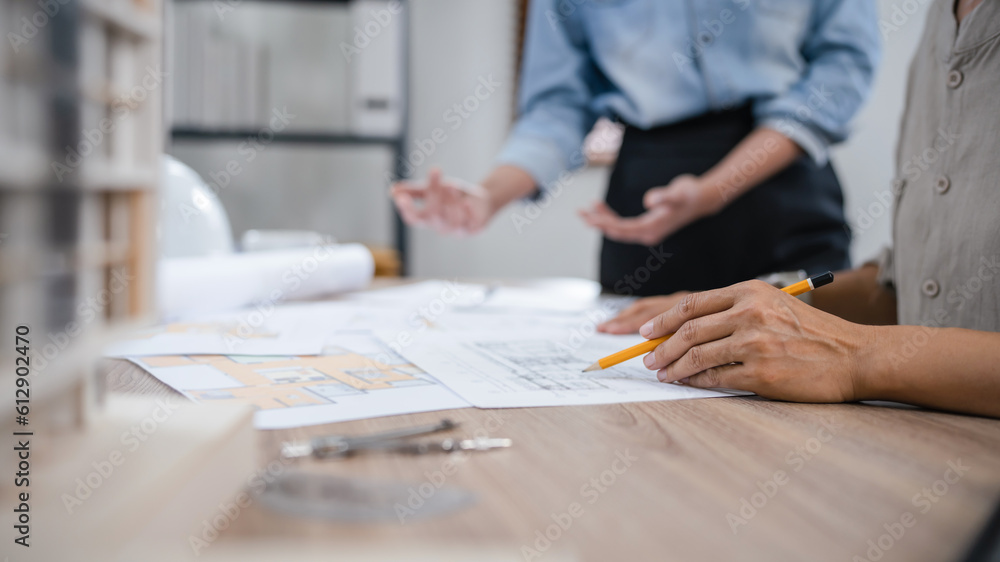 Architects interior designer hands working with Blue prints and documents for a home renovation for house design Architects interior designer hands working with Blue prints and documents for a home renovation for house design
