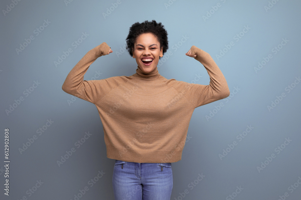 young attractive latin woman with black afro hair pulled back in ponytail isolated on background with copy space young attractive latin woman with black afro hair pulled back in ponytail isolated on background with copy space