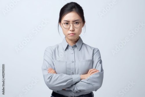 Portrait of young Asian businesswoman standing with arms crossed isolated on white background. Generative AI