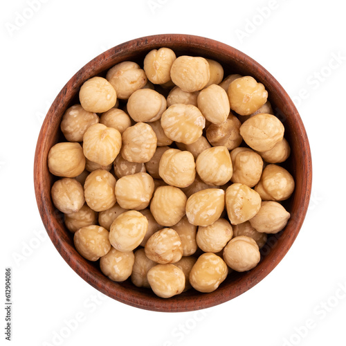 roasted hazelnuts in wooden bowl, crisp toasted nuts of hazel, shelled whole seeds of cobnuts or filbert nuts, macro food photo, close up from above isolated on white background