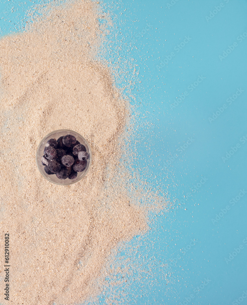 Tropical sea beach with sand, ocean, glass o berries . Flat lay concept