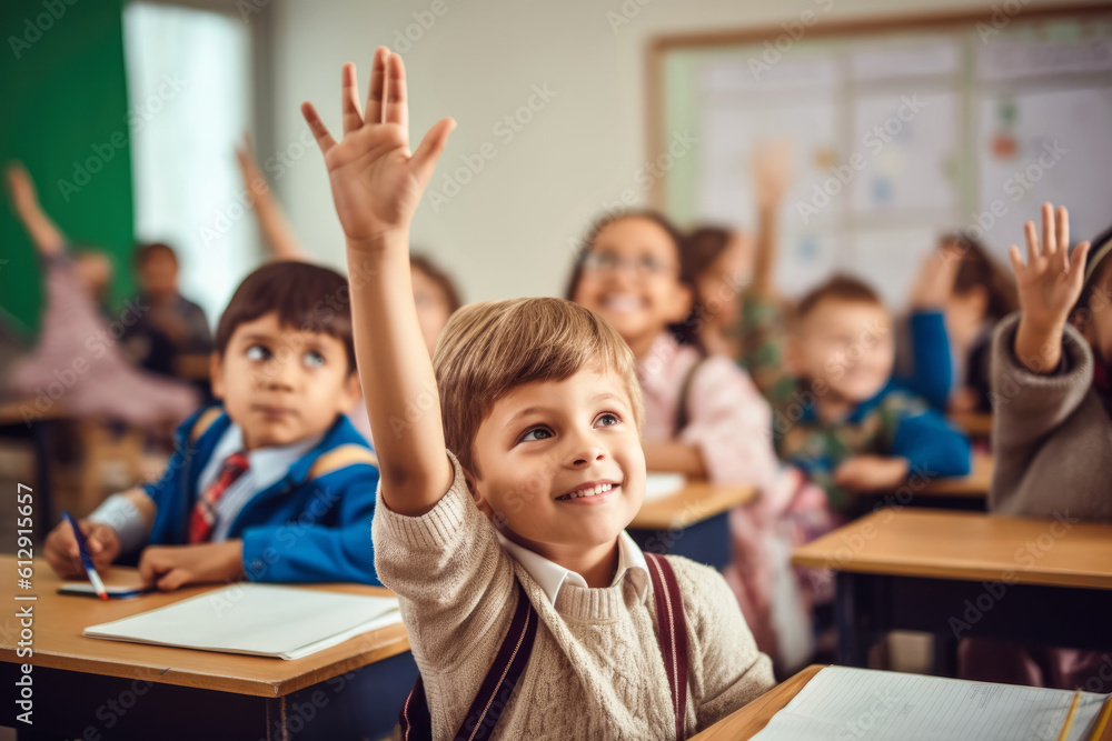 Small boy kid in school classroom raising hand up to answer teacher ...