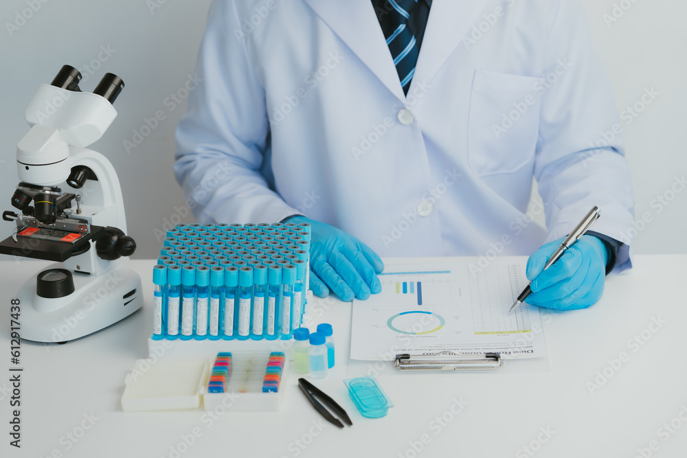 Close up view of scientist analyzing a liquid in the test tubes in laboratory.