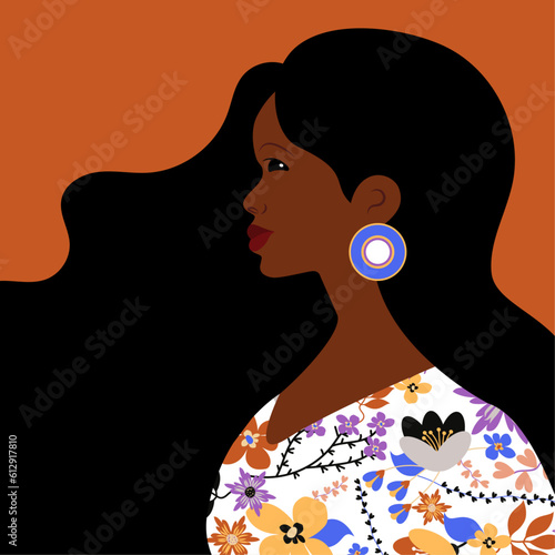 Beautiful black woman. Young african american. Portrait of young woman with beautiful face and hair. Side view. Isolated on orange background.