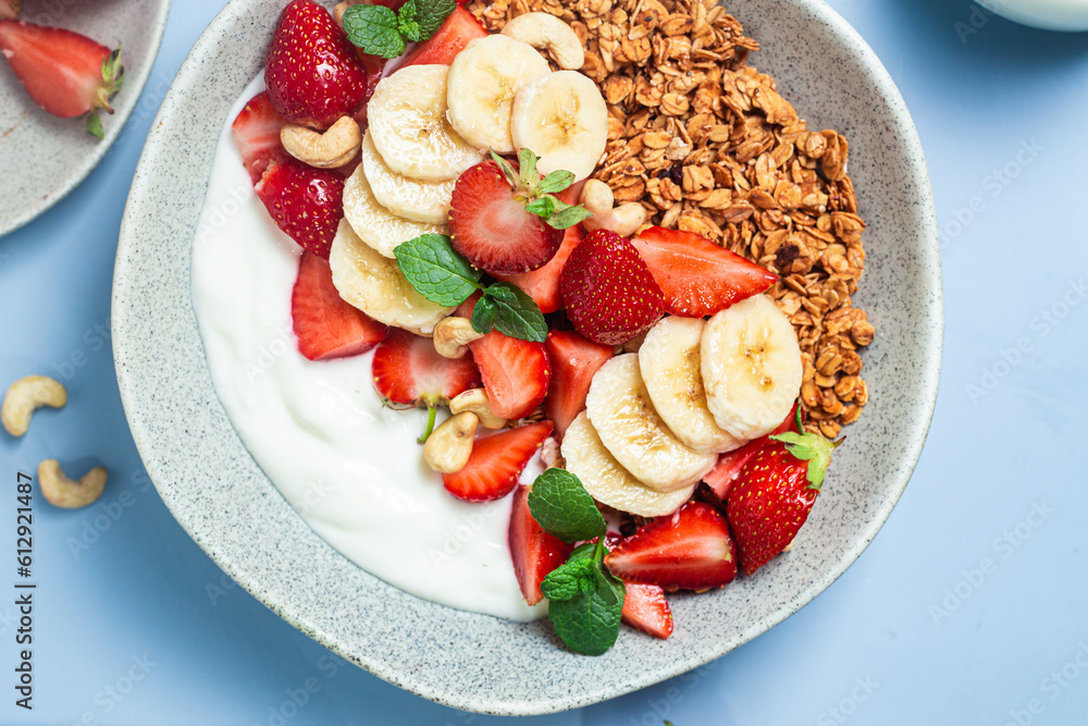 Granola with yogurt, strawberry and banana in a bowl Granola with yogurt, strawberry and banana in a bowl