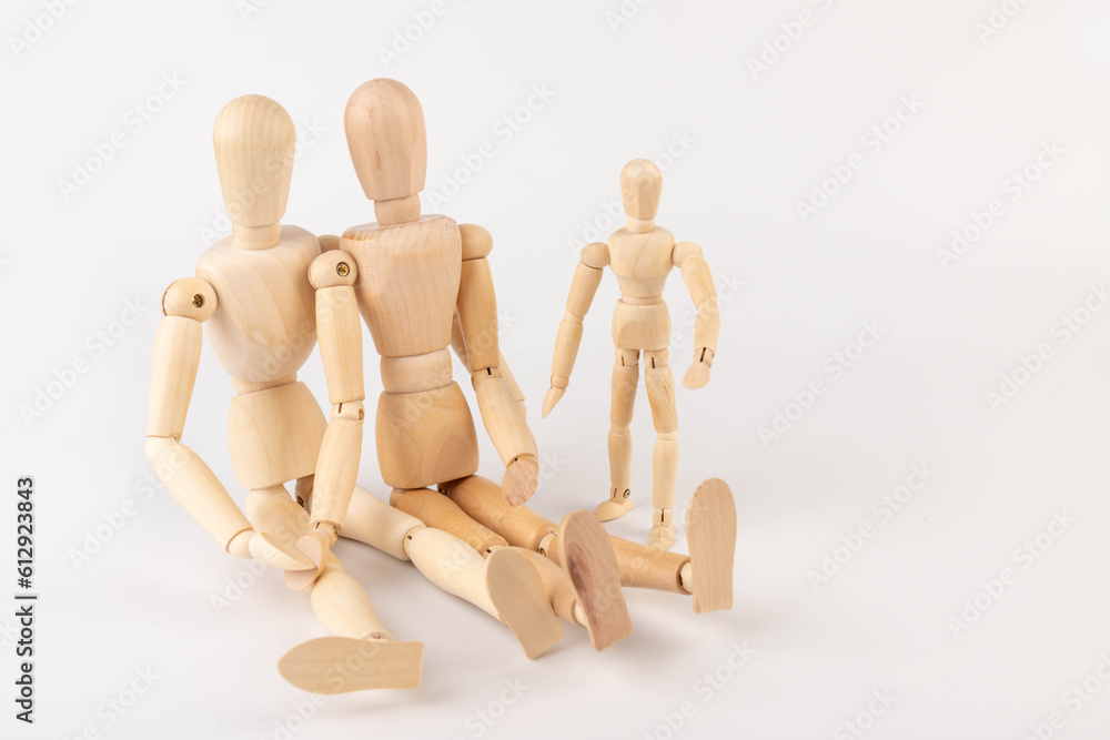 Family of wooden puppets with the kid on white background. Family of wooden puppets with the kid on white background.
