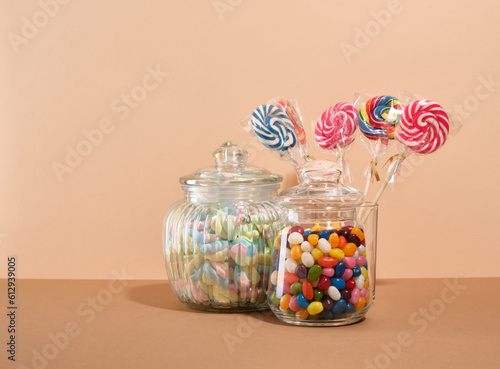 Sweet composition. Candy, marshmallows and lollipops collection on a beige background. Copy space for text.