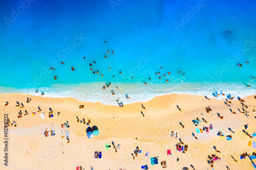 A drone view of the beach and the sea. People on vacation. Vacation and holidays. Summer time for sea travel. The sea bay. Photo for background and wallpaper. Mediterranean Sea.