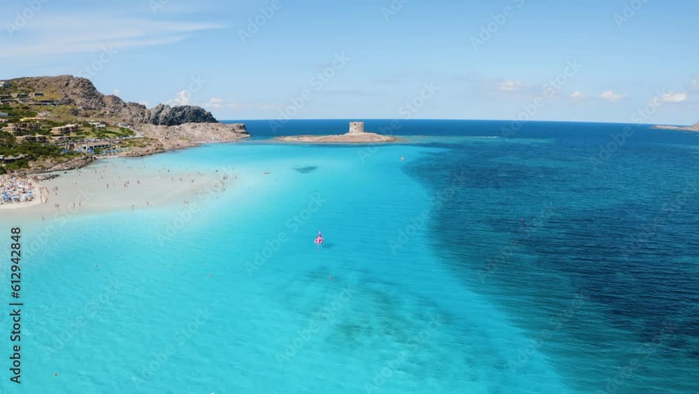 Aerial view of famous La Pelosa beach at sunny summer day. Stintino, Sardinia island, Italy. Top view of white sandy beach, umbrella, swimming people, clear blue sea, old tower. Tropical seascape Aerial view of famous La Pelosa beach at sunny summer day. Stintino, Sardinia island, Italy. Top view of white sandy beach, umbrella, swimming people, clear blue sea, old tower. Tropical seascape