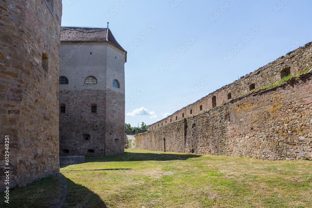 Protective walls of the incredible historical Fagaras Fortress on a sunny day. Transylvania. Romania