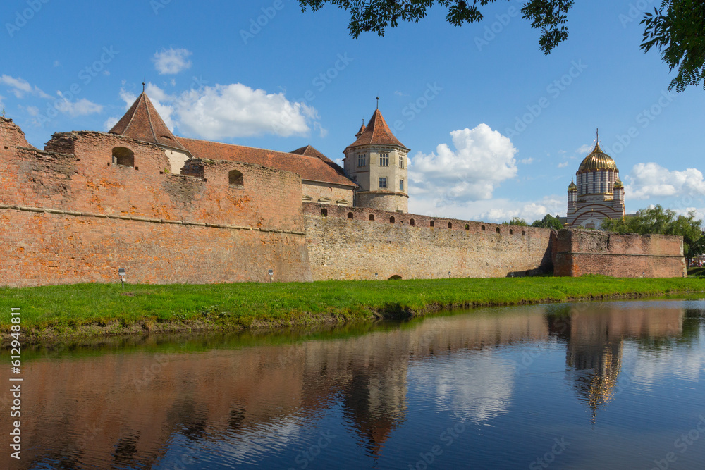 View of the Cathedral of St. John the Baptist and the historical Fagaras Fortress wall. Transylvania. Romania