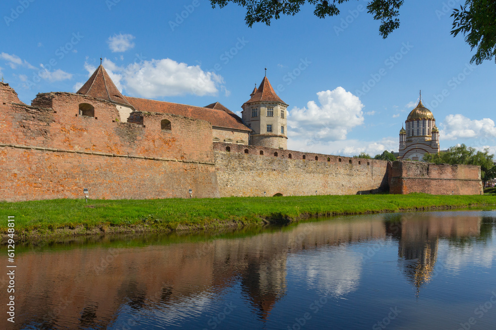 View of the Cathedral of St. John the Baptist and the historical Fagaras Fortress wall. Transylvania. Romania View of the Cathedral of St. John the Baptist and the historical Fagaras Fortress wall. Transylvania. Romania