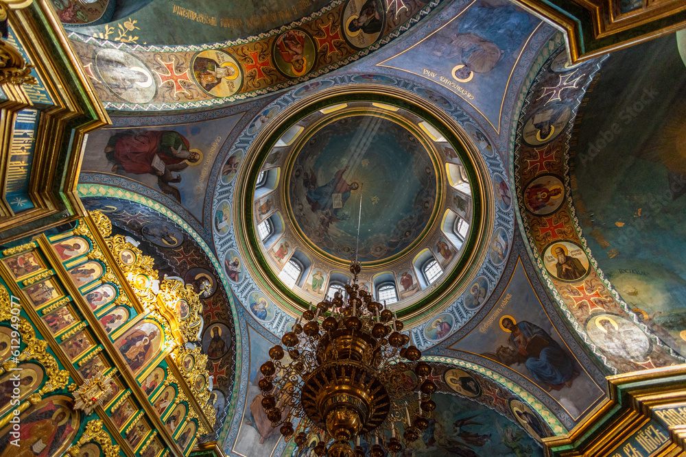 Beautiful dome in an orthodox cathedral, church. Beautiful Christian murals. The sun's rays illuminate the dome beautifully. Beautiful mural with Jesus Christ. Apostles and icons.