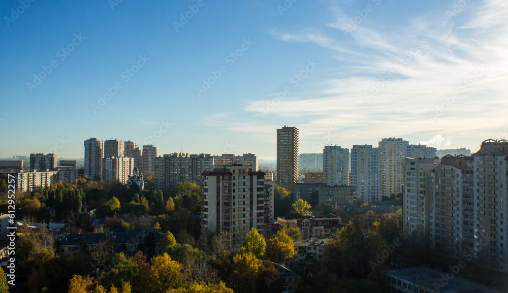 Panoramic urban landscape - multi-storey modern houses of Reutov in the Moscow region among the lush foliage of trees on a clear autumn morning and a space for copying