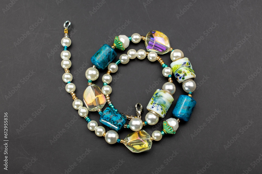Unique colorful gemstone necklace, handmade jewelry concept, promotional photo for an online jewelry store Unique colorful gemstone necklace, handmade jewelry concept, promotional photo for an online jewelry store