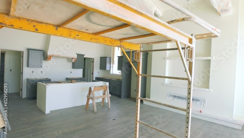 New Southwest Home Construction Freshly Painted Move Under Scaffolding to Kitchen. slow motion view in new home construction freshly painted interior moving under scaffolding toward kitchen