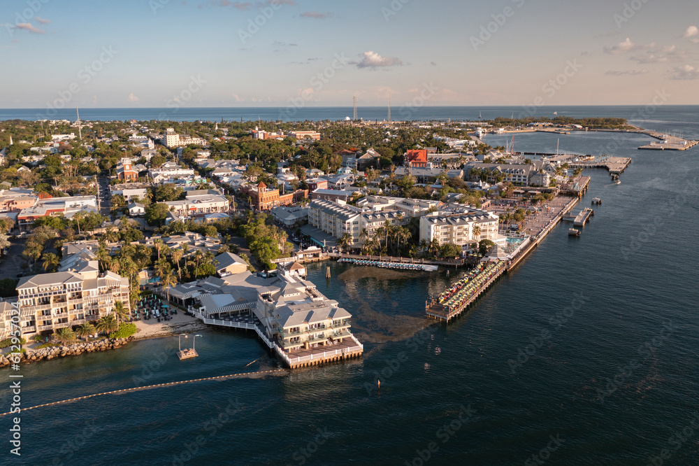 Aerial view of Key West, Florida dowtown cityscape and harbor coast landscape with Mallory Square during golden hour sunset 