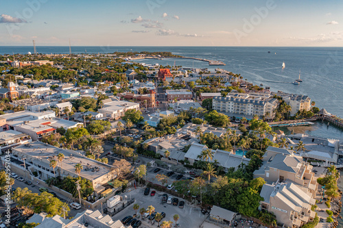 Aerial view of downtown Key West, Florida cityscape and ocean coastal landscape with Mallory Square during golden hour sunset  photo