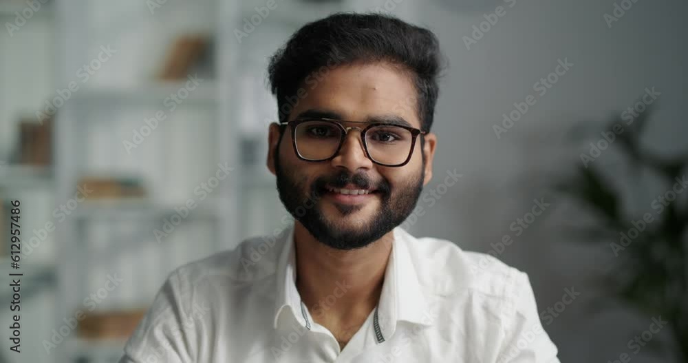 Portrait of a Indian entrepreneur sitting at his office and looking at camera. Portrait of a Indian entrepreneur sitting at his office and looking at camera.