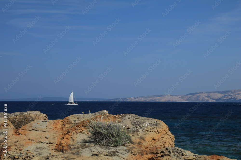 White sailboat on the background of the blue Adriatic Sea