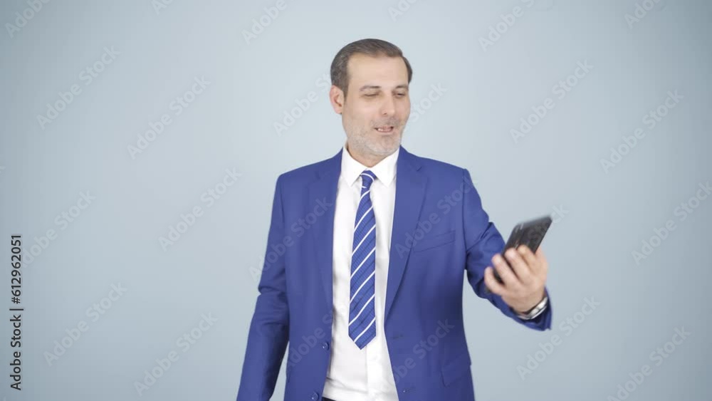Video of businessman making video call on phone. Video of businessman making video call on phone.