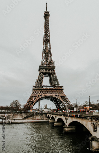 view of the Eiffel Tower in Paris and a bridge on a cloudy day
