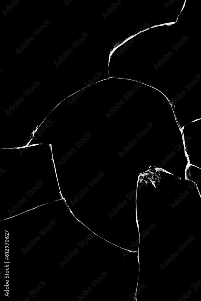 Light texture of cracks of broken glass on a black background. Broken window effect. Light texture of cracks of broken glass on a black background. Broken window effect.