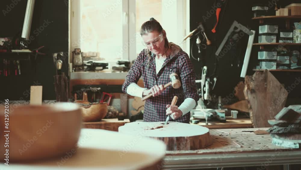 Craftswoman working with wood in carpentry workshop
Craftswoman working with wood in carpentry workshop