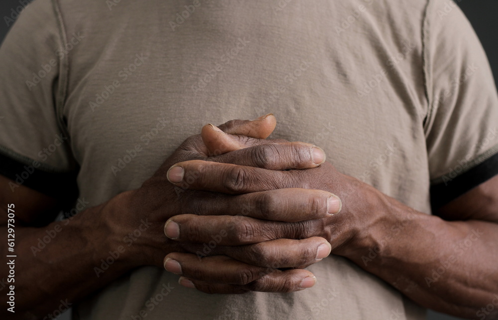 Fototapeta premium man praying to god with hands together on dark background stock photo 