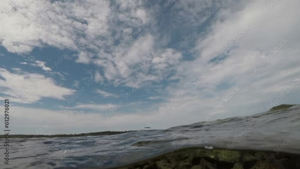sea waves filmed along and below the surface of the sea, clear sky, Adriatic sea, Croatia, slow motion sea waves filmed along and below the surface of the sea, clear sky, Adriatic sea, Croatia, slow motion