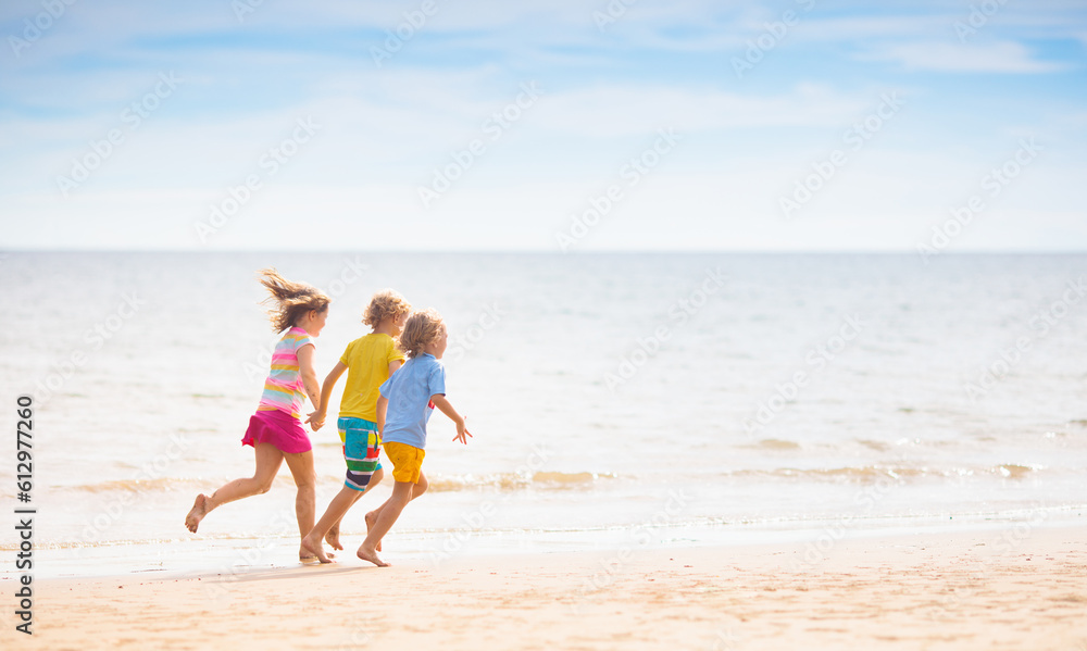 Kids play on tropical beach. Sand and water toy.