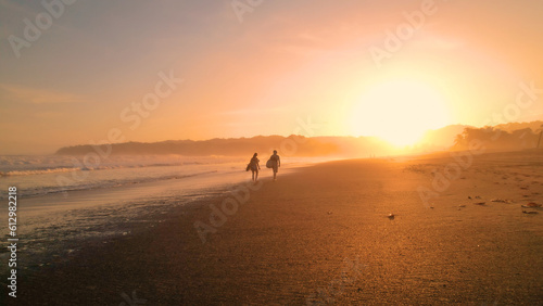 Photography AERIAL: Two friends share their impressions of surfing while walking on beach
