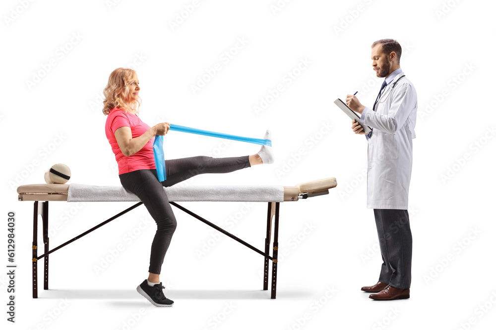 Obraz premium Woman exercising leg with a resistance band and doctor writing a document