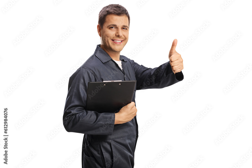 Car mechanic gesturing thumbs up and holding a clipboard Car mechanic gesturing thumbs up and holding a clipboard